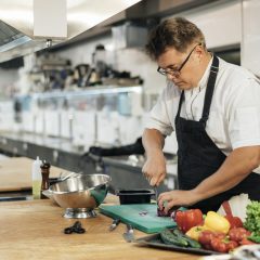 male-chef-with-apron-chopping-vegetables-scaled.jpg